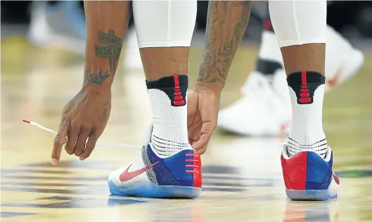  ?? Picture: GETTY IMAGES ?? ADJUSTING TIES: US basketball star DeMar DeRozan reties the laces on one of his sneakers during a US basketball showcase exhibition game against Argentina in July
