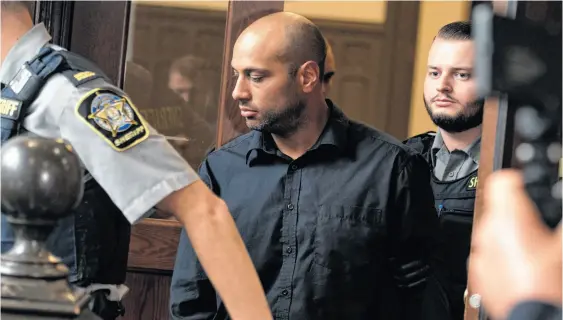  ?? RYAN TAPLIN ■ THE CHRONICLE HERALD ?? Alexander Pishori Levy, a former bouncer at the Halifax Alehouse, is led out of Halifax provincial court Wednesday, Aug. 16, 2023, after his arraignmen­t on charges of manslaught­er and criminal negligence causing the death of Ryan Sawyer last December. Levy, 38. was released on bail with the Crown’s consent.