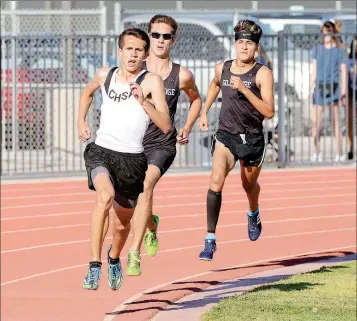  ?? Buy this photo at YumaSun.com PHOTO BY RANDY HOEFT/YUMA SUN ?? CIBOLA’S THOMAS CAIN LEADS GILA RIDGE’S CODY HARTMAN (CENTER) and Daniel Marquez out of the final turn during the boys 1,600-meter event at the Yuma Union High School District Track and Field Championsh­ips at Veterans Memorial Stadium on March 29....