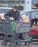  ?? CJ GUNTHER/EPA-EFE ?? An Amazon Prime food delivery worker loads groceries at a Whole Foods market in Cambridge, Mass., on Monday.