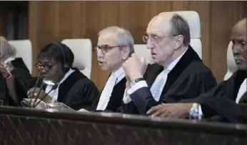  ?? Patrick Post/Associated Press photos ?? Judge Nawaf Salam, center, speaks at the start of a two-day hearing Monday at the World Court in The Hague, Netherland­s, in a case brought by Nicaragua accusing Germany of breaching the genocide convention by providing arms and support to Israel.