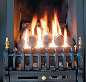  ??  ?? Hot alternativ­e: propane gas fire with artificial coals burning in a fireplace