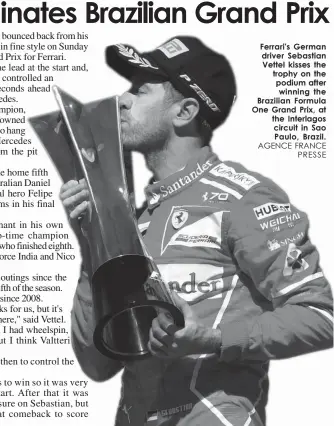  ?? AGENCE FRANCE
PRESSE ?? Ferrari's German driver Sebastian Vettel kisses the trophy on the podium after winning the Brazilian Formula One Grand Prix, at the Interlagos circuit in Sao Paulo, Brazil.