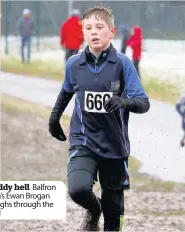  ??  ?? Muddy hell Balfron High’s Ewan Brogan ploughs through the mud