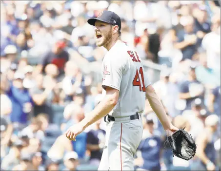  ?? Elsa / Getty Images ?? Red Sox pitcher Chris Sale has words with home plate umpire Mike Estabrook as he leaves the game in the fourth inning against the Yankees during game one of a doublehead­er on Saturday.
