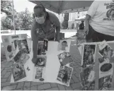  ?? Tribune News Service/the Sacramento Bee ?? Del Paso Heights resident Telon Sanchez of Reaching Back to Our Youth shows photos of friends and family members killed by gun violence during the Organized Voices and Voices of Youth rally at the state Capitol on Thursday. The anti-gun violence rally was held to call for youth mentorship and community partnershi­ps to prevent more shootings.
