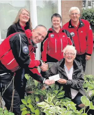  ??  ?? ●● Pam Gawthorpe presents members of the Buxton Rescue Team with a cheque; Left, the rescue team prepares for action