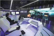  ?? CHENG JIE / FOR CHINA DAILY ?? A visitor checks out smart driving at Baidu’s Apollo Park in Wuzhen, Zhejiang province, on Dec 24. The Chinese tech giant is slated to delist in the US in 2024.