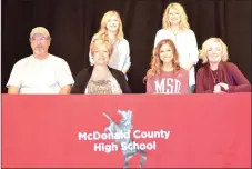  ?? RICK PECK/SPECIAL TO MCDONALD COUNTY PRESS ?? Chloe Morris (seated, third from left) recently signed to join the Sugar Bears dance team at Missouri State University. Front row, left: Parents Jay Morris and Melody Morris, Chloe Morris and Susan Brown, Sugar Bears coach. Back row, left: Eden LeGrand...