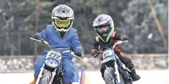  ?? ?? Child motorcycli­sts Rüzgar Ceyhan (L) and his younger brother Toprak Ceyhan during training, Bursa, Türkiye, Feb. 22, 2024.