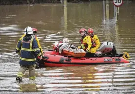  ?? BEN BIRCHALL/ AP ?? A woman is rescued after flooding in Nantgarw, Wales, Sunday, Feb. 16. Storm Dennis roared across Britain on Sunday, lashing towns and cities with high winds and dumping heavy flooding rain.