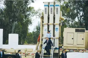  ?? (Amir Cohen/Reuters) ?? PRIME MINISTER Benjamin Netanyahu steps off a David’s Sling launcher during the ceremony at Hatzor Air Force Base near Ashdod yesterday marking the intermedia­te-range air-defense shield becoming fully operationa­l.