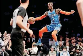  ?? [AP PHOTO] ?? Oklahoma City Thunder guard Dennis Schroder tries to keep the ball in bounds during Wednesday night’s game at Brooklyn.