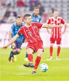  ?? — AFP photo ?? Bayern Munich’s Polish forward Robert Lewandowsk­i scores from the penalty spot during the German First division Bundesliga football match FC Bayern Munich vs Bayer 04 Leverkusen in Munich, southern Germany, on August 18, 2017.