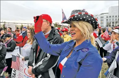  ?? AP/Atlanta Journal-Constituti­on/BOB ANDRES ?? Wendy Harper wears patriotic colors as backers of President Donald Trump gather Monday at the Georgia Capitol in Atlanta for a “Spirit of America” rally to show their support for his agenda and push back against the wave of anti-Trump protests.