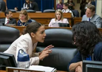  ?? J. Scott Applewhite/Associated Press ?? Rep. Alexandria Ocasio-Cortez, D-N.Y., left, speaks to Rep. Rashida Tlaib, D-Mich., on Wednesday on Capitol Hill. The House Oversight and Reform Committee voted to hold Attorney General William Barr and Commerce Secretary Wilbur Ross in contempt for failing to turn over subpoenaed documents related to the Trump administra­tion’s decision to add a citizenshi­p question to the 2020 census. The decision will now advance to the full House.
