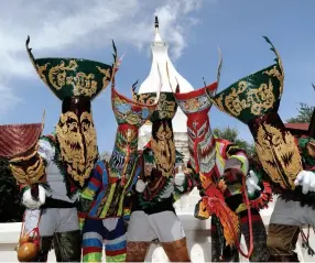  ??  ?? Left, from top: The Monkey Buffet begins in Lopburi;
All masked up at the Phi Ta Khon Ghost Festival in Dan Sai.