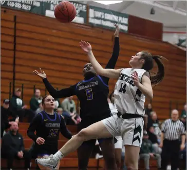  ?? RANDY MEYERS — FOR THE MORNING JOURNAL ?? Elyria Catholic’s Isabelle Niederst and Clearview’s Mo’Faith Tillman compete for a rebound in the first quarter on Feb. 21.