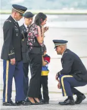  ?? Bob Owen / San Antonio Express-News ?? Widow Shannon Ray and son Dean Ray, 5, weep as Lt. Clovis Ray’s remains are returned. 1 France: Gears up to recall the end of WWI. A23