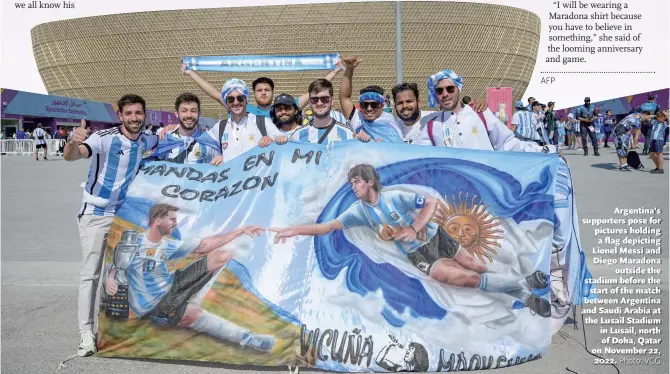  ?? Photo: VCG ?? Argentina’s supporters pose for pictures holding a flag depicting Lionel Messi and Diego Maradona outside the stadium before the start of the match between Argentina and Saudi Arabia at the Lusail Stadium in Lusail, north of Doha, Qatar on November 22, 2022.