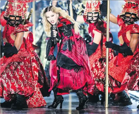  ?? RICH FURY/THE ASSOCIATED PRESS ?? Madonna made ambitious costume changes, revolution­ary lighting and complicate­d dance routines her signature.