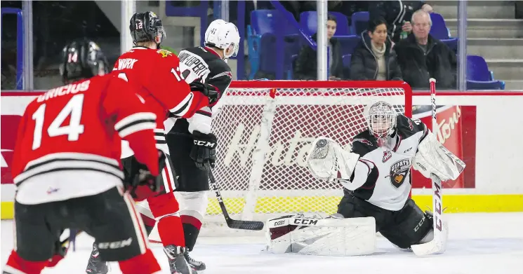  ?? RIK FEDYCK/VANCOUVER GIANTS ?? Vancouver Giants goalie David Tendeck makes a glove save against the Portland Winterhawk­s, who beat the Giants 5-3 in Monday’s game.