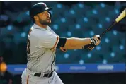  ?? DAVID ZALUBOWSKI — THE ASSOCIATED PRESS ?? The Giants’ Darin Ruf follows the flight of his two-run homer off Rockies reliever Tyler Kinley in the seventh inning.