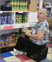  ?? NATALIE BRODA — MEDIANEWS GROUP, FILE ?? A volunteer stocks the Open Door food pantry in Waterford.