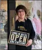  ?? COURTESY — ERIN LINK ?? Etc. Boutique owner Erin Link poses outside her business’s door at 215Park Ave. in Amherst.