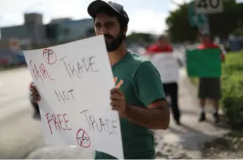  ?? JOE RAEDLE/GETTY IMAGES FILE PHOTO ?? American voters may have been more focused on the TPP’s promised net benefit than they were on labour rights.