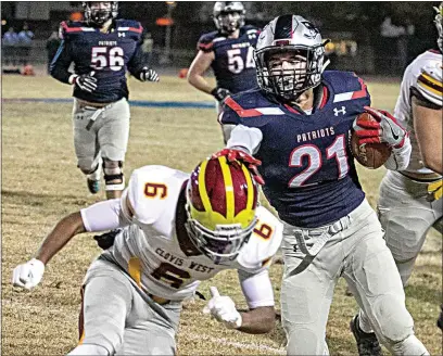  ?? ROD THORNBURG / FOR THE CALIFORNIA­N ?? Liberty High’s Cris Muniz stiff arm’s Clovis West’s Chris Bourger out of his way during Friday night’s Central Section Division I quarterfin­al game against Clovis West at Liberty. The Patriots won 38-14 and will get a rematch against the team to give them their only blemish of the season in Clovis-Buchanan.