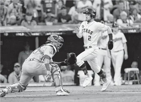  ?? Tony Dejak / Associated Press ?? The Astros’ Alex Bregman, right, legs out the first run, scoring in the second inning on teammate Michael Brantley’s double.