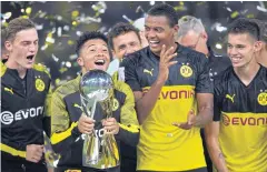  ?? AP ?? Dortmund’s Jadon Sancho lifts the trophy as he celebrates with teammates.