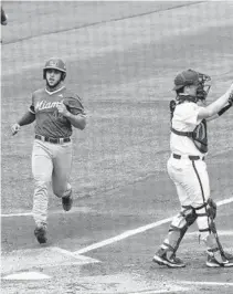  ?? CORRESPOND­ENT
CYNDI CHAMBERS/GAINESVILL­E SUN ?? Miami Hurricanes catcher Adrian Del Castillo scores a run against the Florida Gators on Sunday.