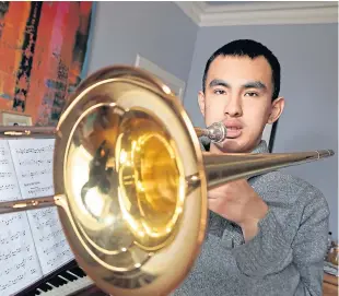  ?? Picture: Gareth Jennings. ?? Everything’s sound: Sebastian Jiang, 21, now reunited with his trombone.