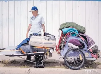  ?? ROBERTO E. ROSALES/JOURNAL ?? A homeless man stands by his belongings on First Street.