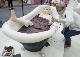  ?? Picture: IAN LANDSBERG ?? SWEET FIGURE: Dot Klerck puts the final touches to a 20kg cake dubbed ‘Bride-in-a-bath’, which is the official cake at the Good Food and Wine Show.