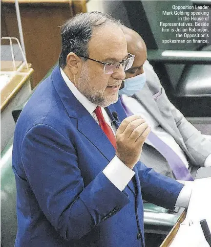  ??  ?? Opposition Leader Mark Golding speaking in the House of Representa­tives. Beside him is Julian Robinson, the Opposition’s spokesman on finance.