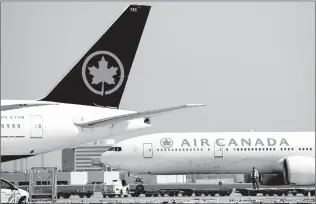  ?? CANADIAN PRESS FILE PHOTO ?? Air Canada planes sit on the tarmac at Pearson Internatio­nal Airport during the COVID-19 pandemic in Toronto earlier this year.