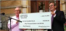  ?? PAUL POST — PPOST@DIGITALFIR­STMEDIA.COM ?? Adirondack Civic Center Coalition President Dan Burke, left, presents a $50,000 check to Glens Falls Mayor Dan Hall, right. It’s the final installmen­t of a $600,000 lease agreement the Coalition has to operate Cool Insuring Arena, previously called...