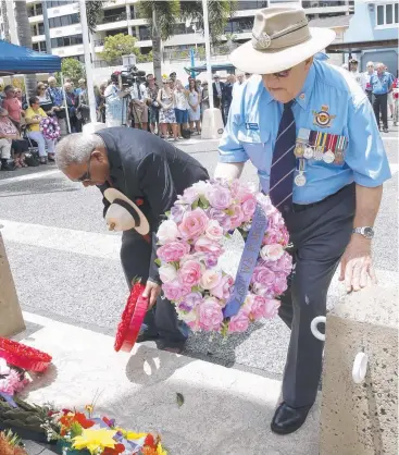  ?? Pictures: ANNA ROGERS ?? MUTUAL RESPECT: Peter Lenoy, on behalf of the indigenous ex-service personnel, and Ralph Gradidge, on behalf of the National Servicemen's Associatio­n of Australia, lay wreaths at the Remembranc­e Day service at the Cenotaph on the Esplanade.