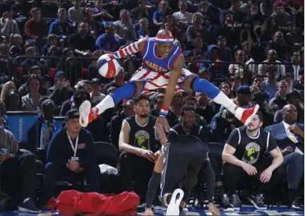  ?? PHOTO PROVIDED ?? Tay Fisher, aka “Firefly”, leaps over an opponent while playing for the Harlem Globetrott­ers basketball team. Fisher recently retired after spending 10 years playing for the Globetrott­ers.