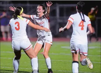  ?? SARAH GORDON/THE DAY ?? Montville’s Amanda Perkins (3) and Michaela MacCracken (13) celebrate Perkins’ goal as teammate Alexis Delucia (4) gets ready to join the celebratio­n during the Indians’ 1-0 win over East Lyme on Wednesday.