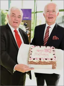  ?? Photo by John Tarrant ?? Gurranabra­her Credit Union Chairman Michael O’Connell presents a birthday cake to Paddy O’Brien, recipient of a Cork and Northside Community Award in the Commons Inn Hotel.