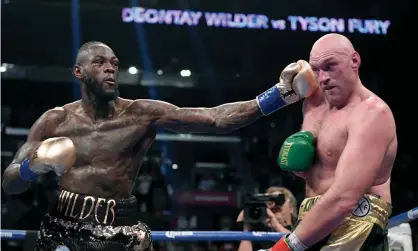  ??  ?? Deontay Wilder punches Tyson Fury during the ninth round of their WBC heavyweigh­t title fight in December 2018. Photograph: Harry How/Getty Images