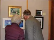  ?? SUBMITTED PHOTO ?? People look at pieces of art displayed in the Scenes of the Schuylkill Exhibit during the artist reception on Nov. 14 at the MCCC West Campus gallery in Pottstown.