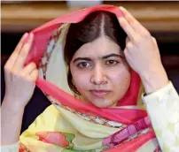  ?? Reuters ?? Malala Yousafzai adjusts her scarf as she speaks during the interview at a local hotel in Islamabad. —