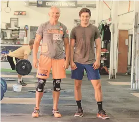  ?? STAFFPHOTO­BYFAITHNIN­IVAGGI ?? IT'S ALL RELATIVE: Bob Caslin, left, works out with his son, Brendan, at the CrossFit Southie facility.