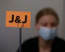  ?? NAncy lAnE / HErAld stAFF FilE ?? USING JOHNSON & JOHNSON: Signs for the Johnson & Johnson COVID-19 vaccine sit on tables as Tufts Medical Center workers get ready to administer the first doses on March 4.