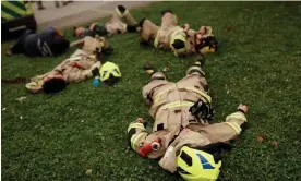  ?? Photograph: Juan González/Reuters ?? Firefighte­rs take a break, after a wildfire burned areas in Santa Juana, near Concepción, Chile, on Sunday.